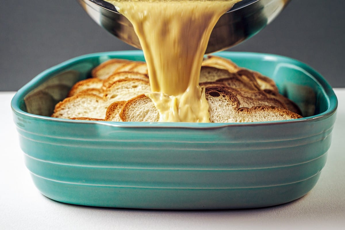 Pouring custard over bread