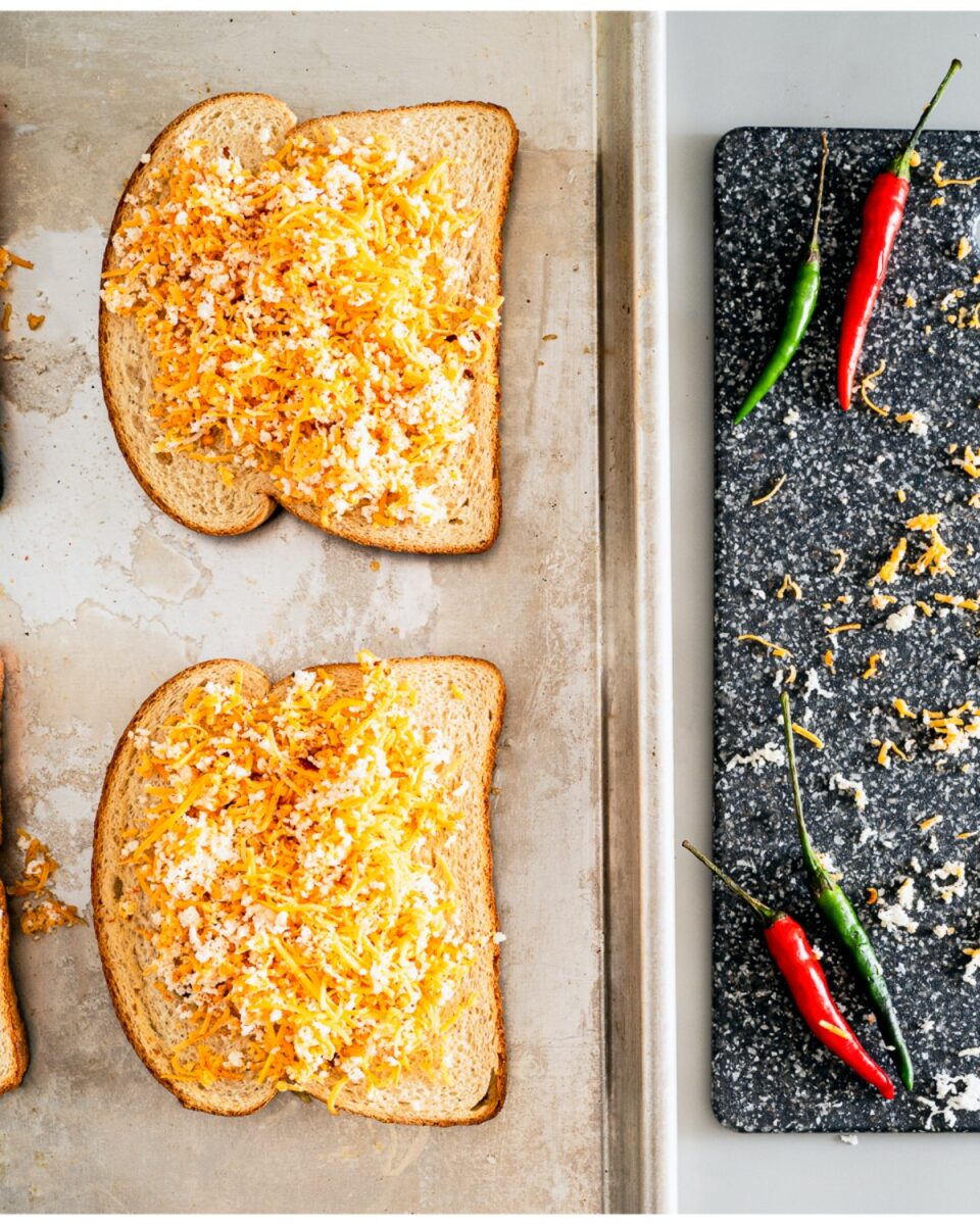 Putting cheese and chili on toast