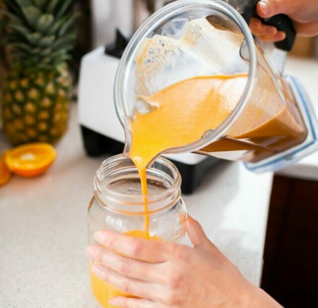 Pouring smoothie into a jar