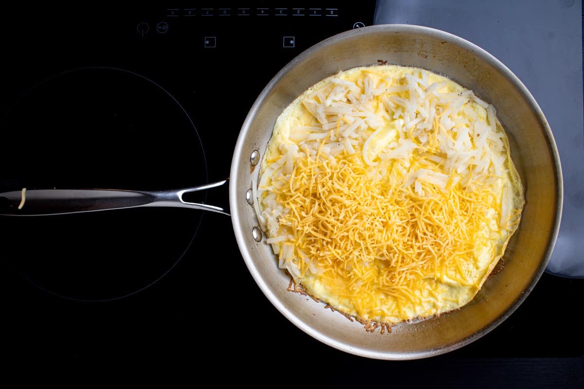 Adding cheese and hash brown