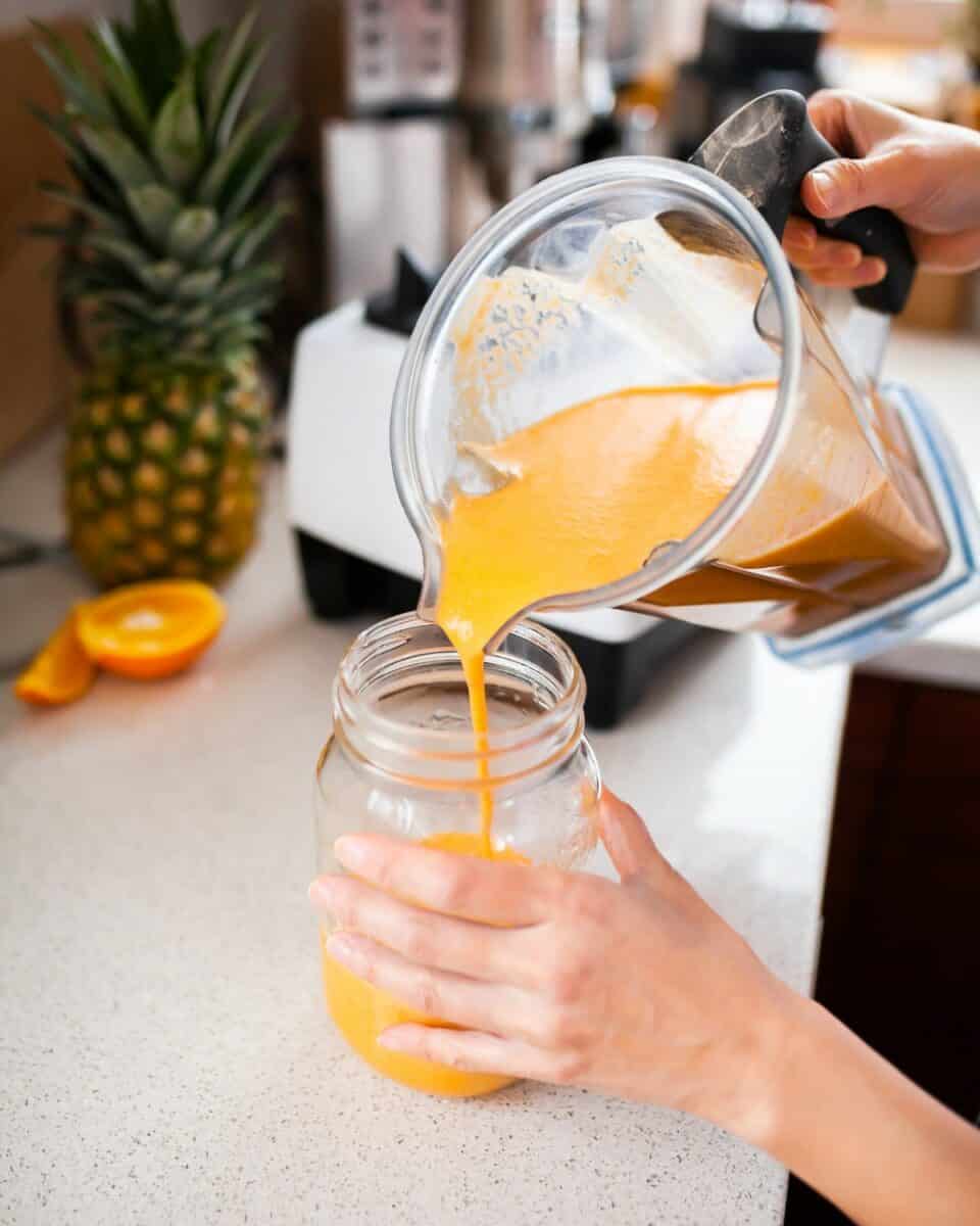 Pouring smoothie into a jar