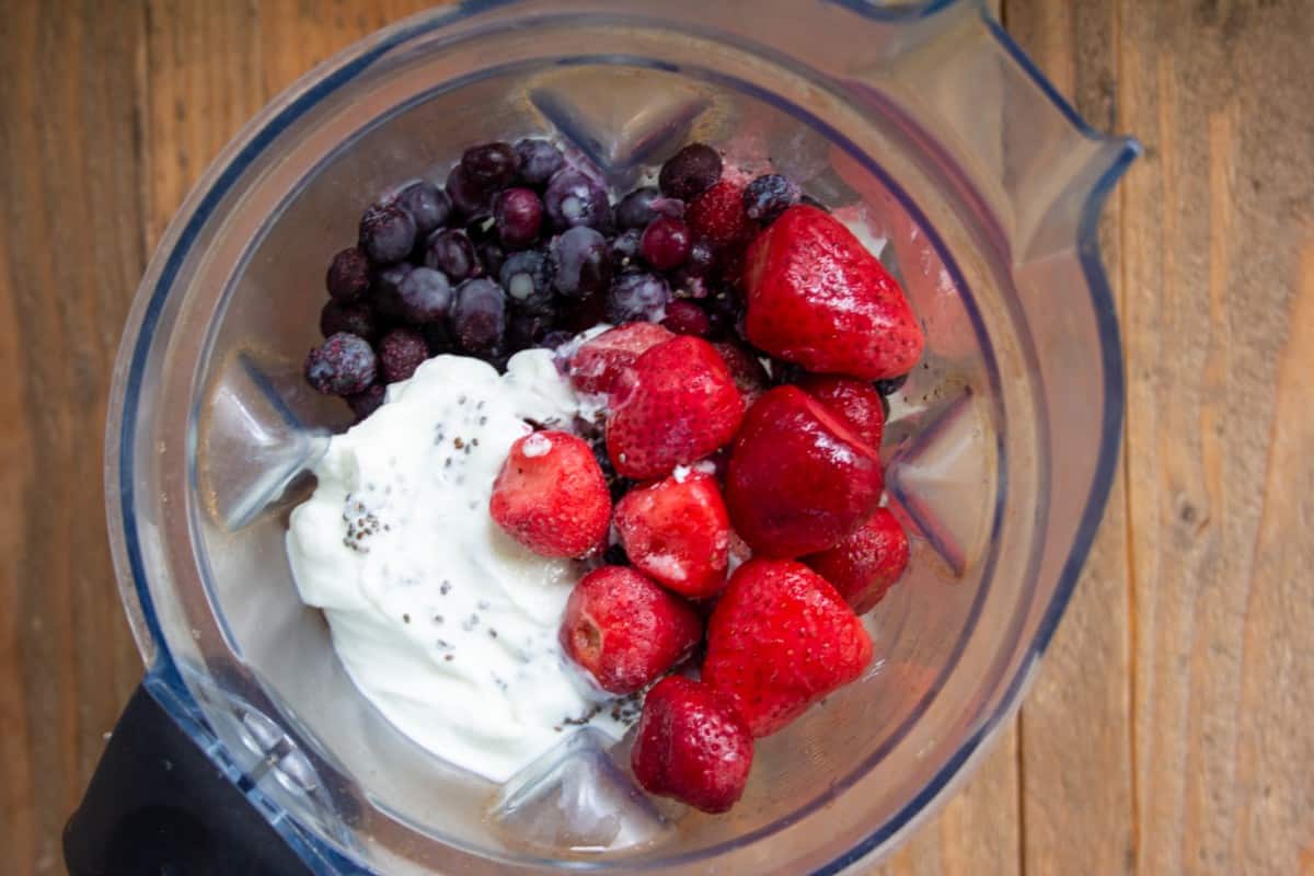 Strawberries and blueberries in a blender