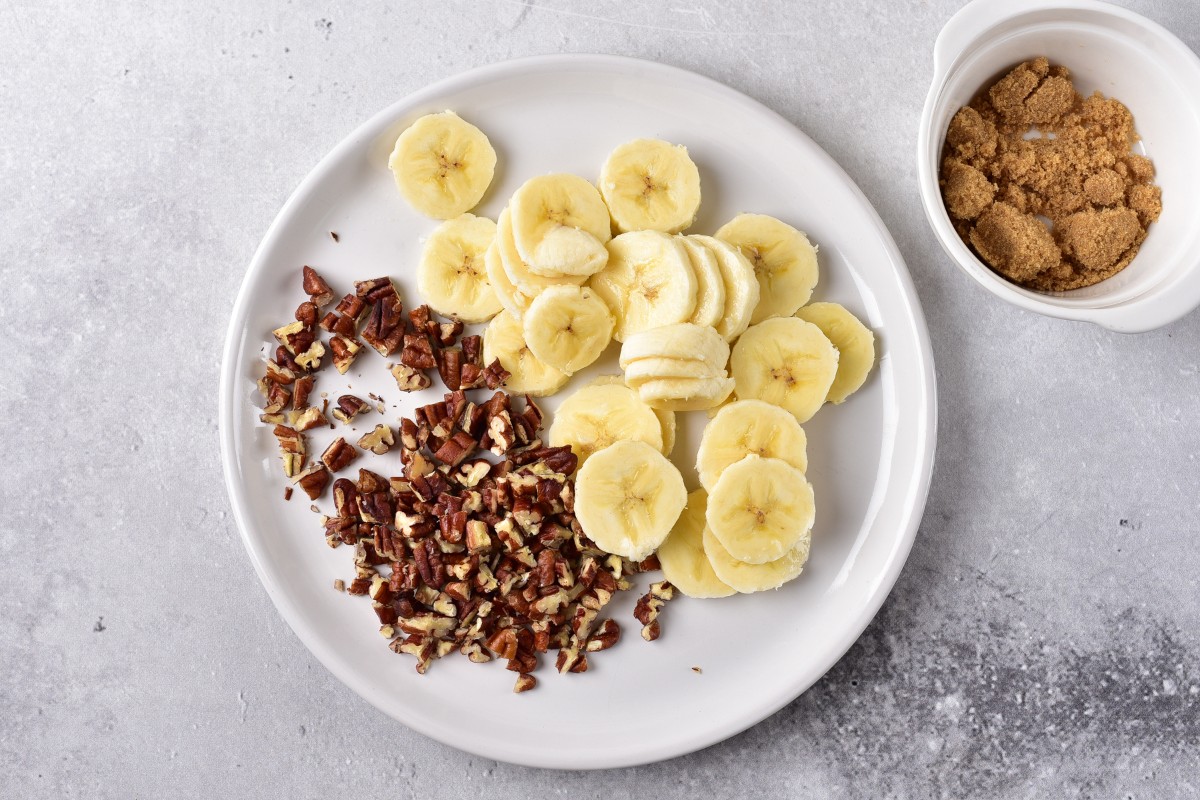 Sliced bananas and pecans on a plate