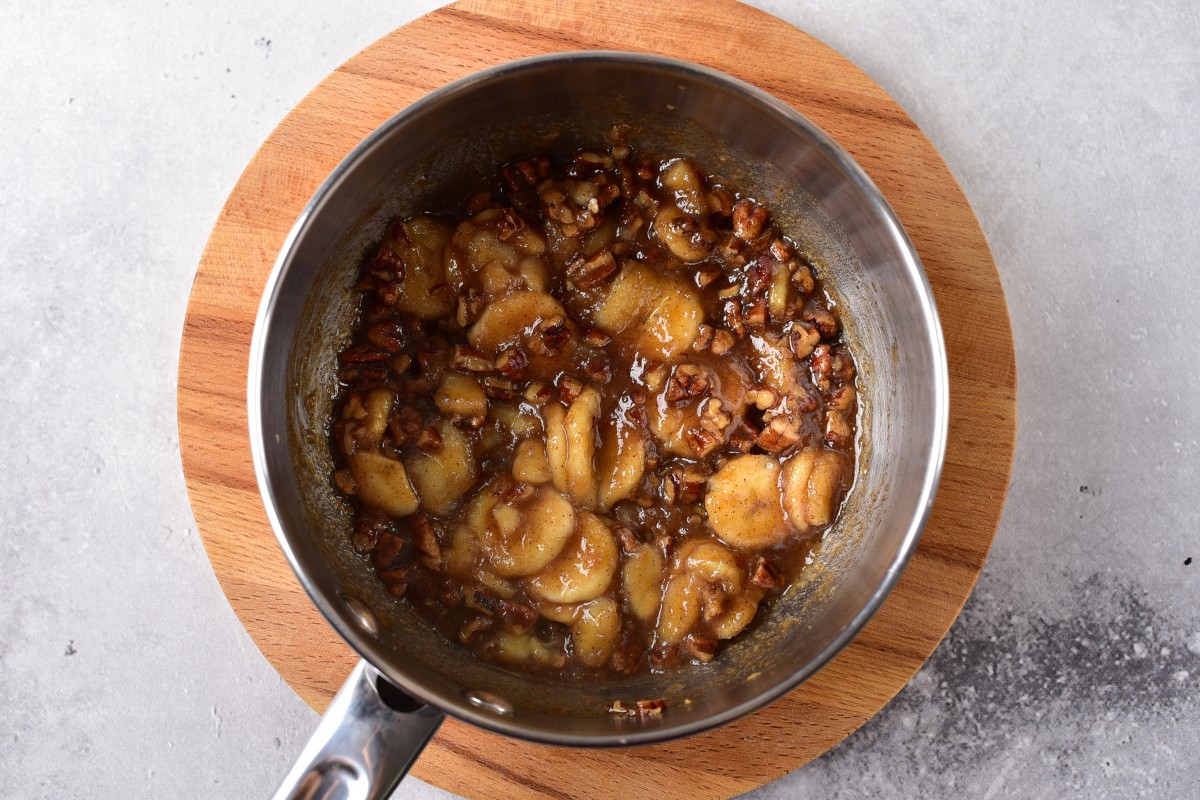 Mixing bananas and pecans with caramel