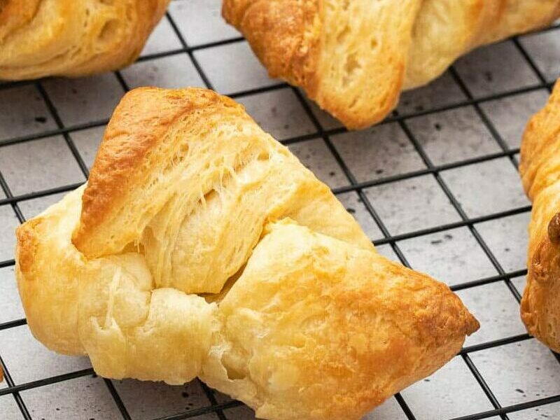 croissants left on a wire rack to cool