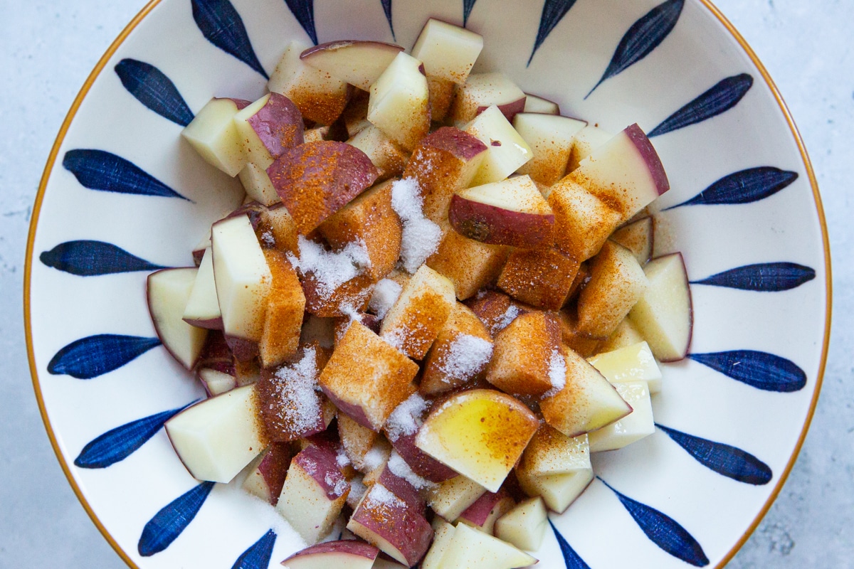 red potatoes, olive oil, paprika, salt, and pepper in a large bowl