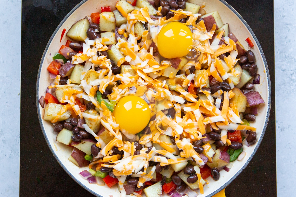 remaining ingredients for Mexican breakfast hash layered in a skillet