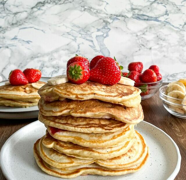 a stack of strawberry banana pancakes