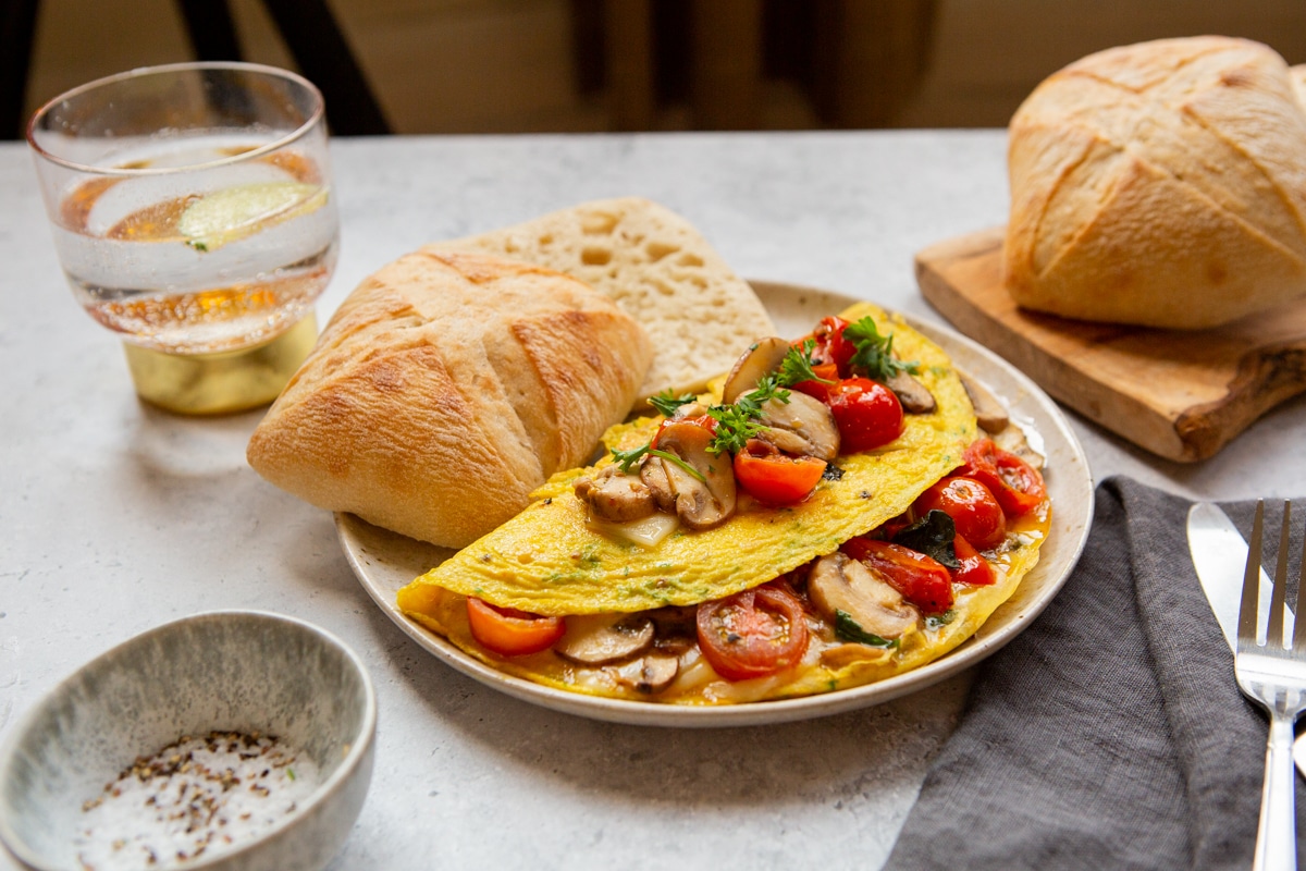 mushroom tomato omelette served on plate